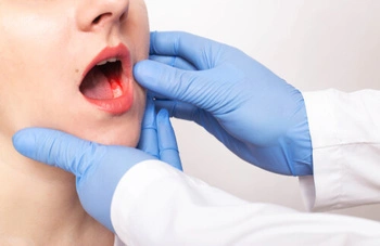 patient showing her mouth to dentist